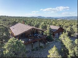 A special home in a private setting amongst the Pinon Pines and spacious 5 acres