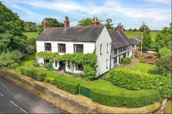 An enchanting Grade II listed prominent village home with attached cottage dating back to 