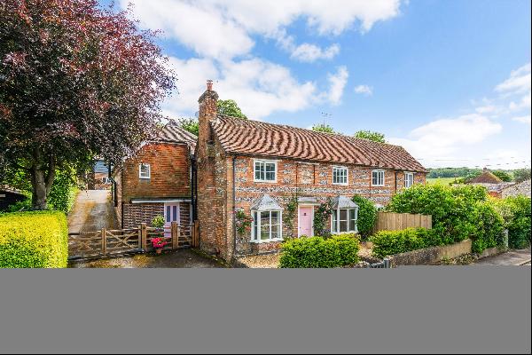 A beautifully presented brick and flint house with an annexe in a sought-after village.