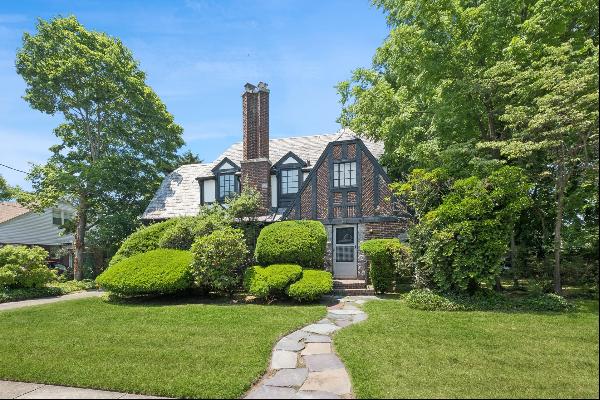 Charming Tudor home offering character and architecture with intricate details, woodwork, 