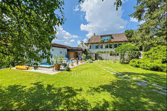 Lugano-Magliaso: charming villa for sale, nestled in lush greenery, featuring a swimming 