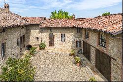 In the heart of Val Luretta, an ancient farmhouse surrounded by greenery