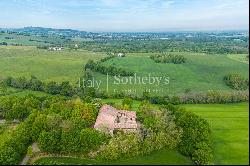 In the heart of Val Luretta, an ancient farmhouse surrounded by greenery