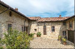 In the heart of Val Luretta, an ancient farmhouse surrounded by greenery