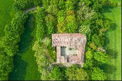 In the heart of Val Luretta, an ancient farmhouse surrounded by greenery