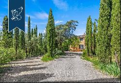 Prestigious farm with over 25 hectares of vineyards, olive trees, forests and a private la