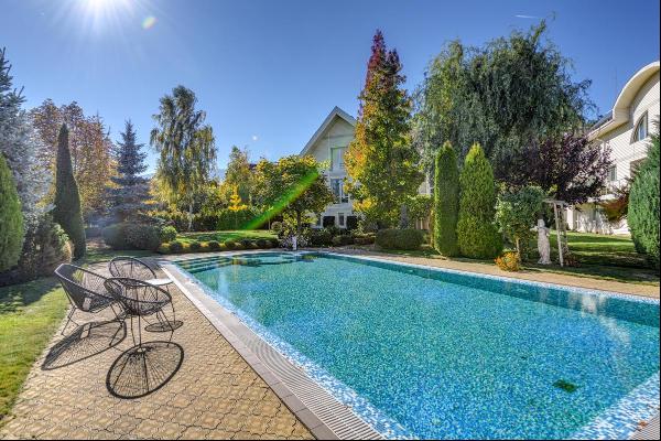 sprawling property with a magnificently landscaped yard with an outdoor pool