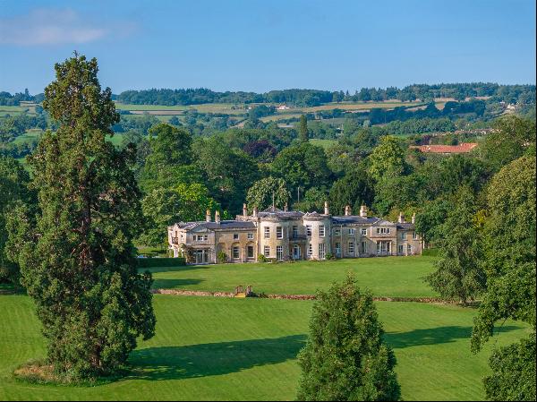 An exceptional Grade II Listed Georgian country house standing in an elevated position wit