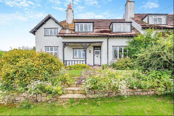 A superb period home with gardens, garaging and parking located part way up Cleeve Hill so