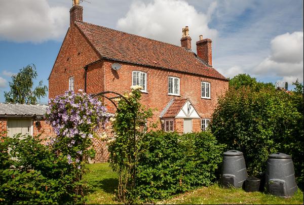 A beautiful Grade II detached former farmhouse with paddock situated in a quiet no through