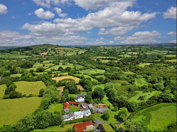 A refurbished 16th century farmhouse set in a tiny hamlet with accompanying period outbuil