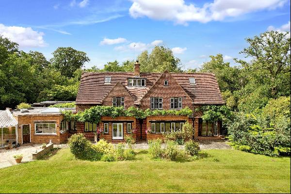 A handsome and substantial Arts and Crafts family home with outbuildings and set in garden