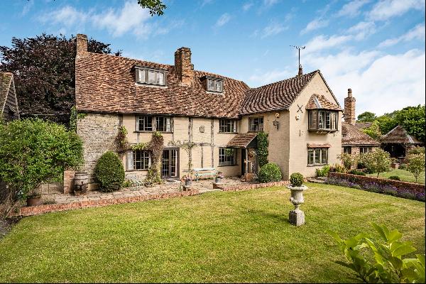 A charming Grade II listed property with expansive gardens extending on to scenic fields