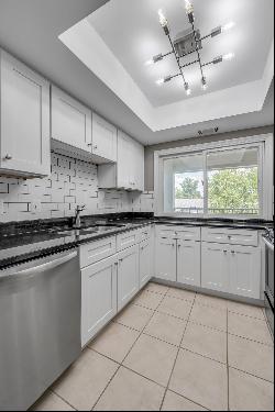 Move in ready two bedroom, two bathroom top floor condo at The Oaks! Convenientl