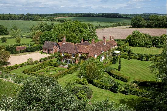 A private and beautifully presented small country estate down a tree lined drive with far 