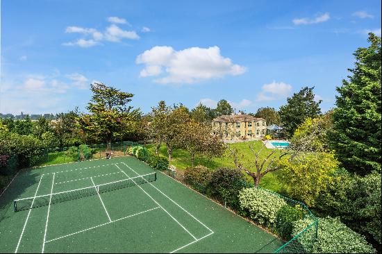 A beautiful Art-Deco family home set in mature gardens with accompanying swimming pool and