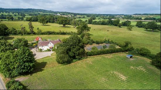 An unlisted former rectory with equestrian facilities in a peaceful setting with views to 