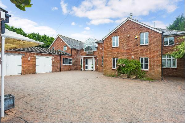 A rural detached house with stables, paddock and tennis court.