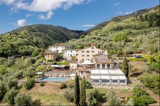 An enchanting estate surrounded by olive groves and vineyards, with panoramic views over t