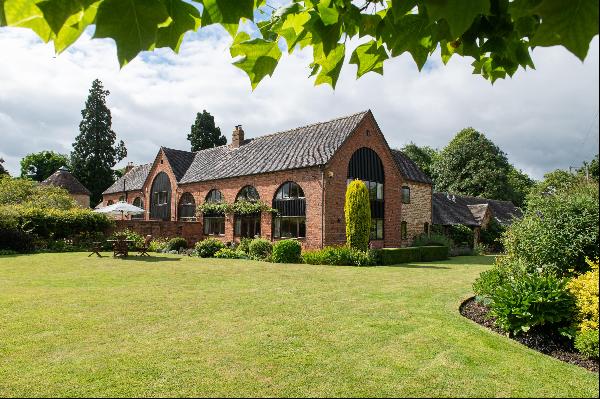 A beautiful listed brick and stone converted Victorian barn in lovely gardens and orchard 