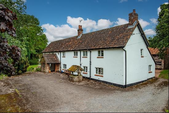 An unlisted, period farmhouse set in over four acres with extensive outbuildings and no ne