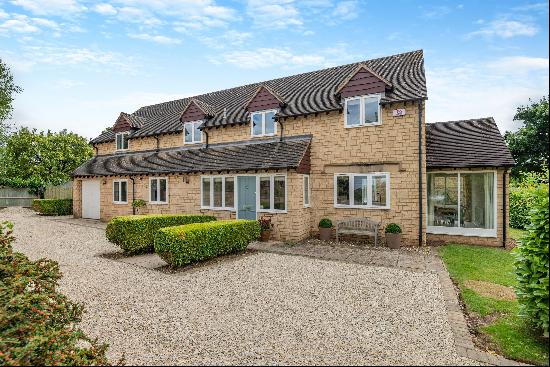 A beautifully presented village home with a south facing garden and planning permission to