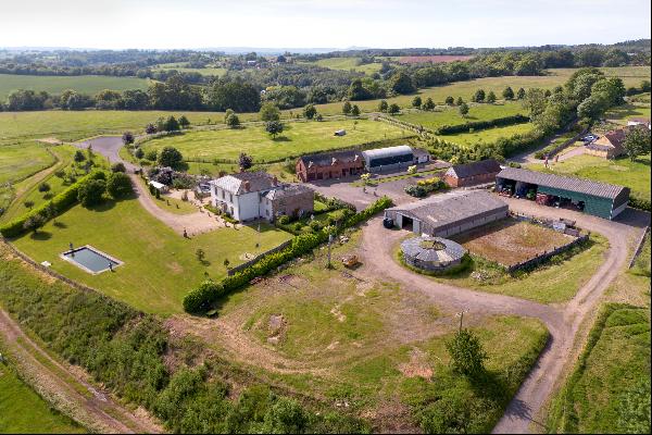 A ring fenced farm centring on a handsome period farmhouse with versatile outbuildings and