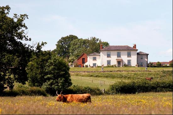 A ring fenced farm centring on a handsome period farmhouse with versatile outbuildings and