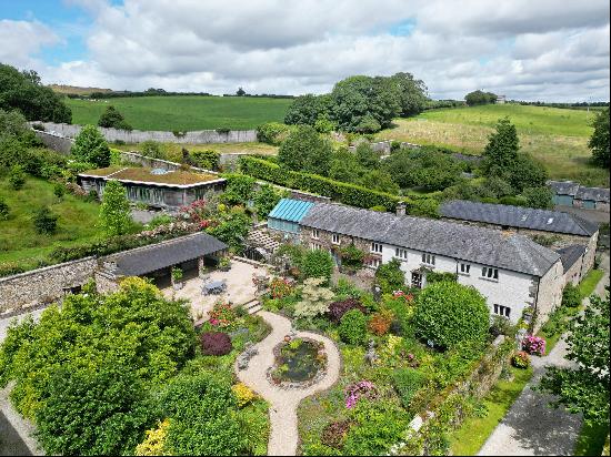 A beautiful  Grade II listed small estate with a five bedroom farmhouse, two cottages, an 