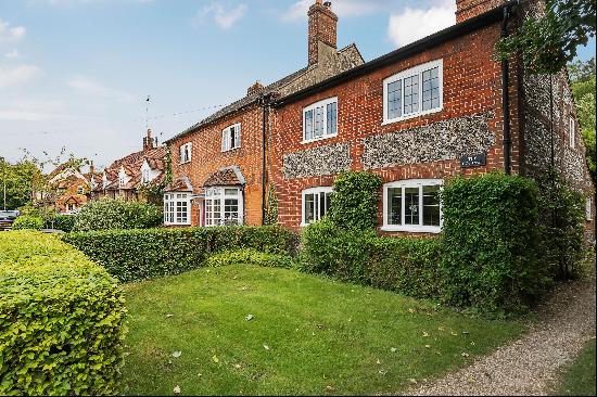 A charming Grade II Listed three bedroom brick and flint cottage.