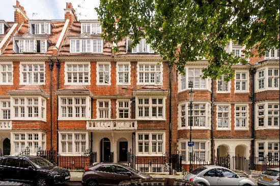 A duplex apartment set in a handsome red brick building off High Street Kensington.