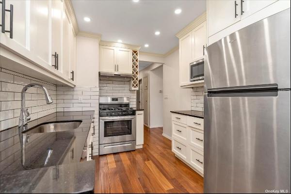 Available now! a remarkable updated legal two family attached brick home in Astoria Height