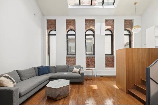 Spanning approximately 1,350 square feet, this unique triplex loft apartment combines o