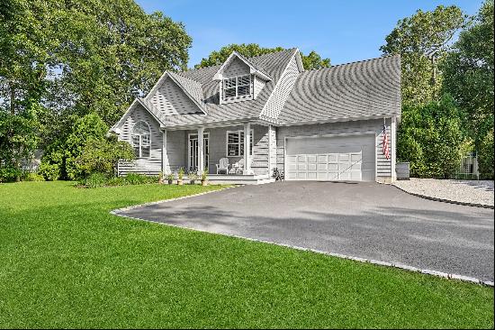 This East Quogue home offers a perfect blend of luxury and comfort, with three spacious be