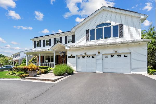 A charming front porch welcomes you to a beautiful 5-bedroom home situated on a fully land