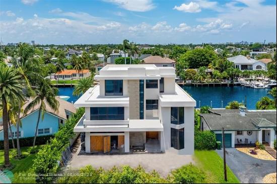 Luxurious three story waterfront estate newly constructed in Lauderdale Harbors. Envisione