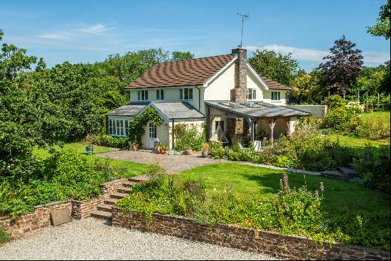 A charming family home with excellent equestrian facilities and just over 19 acres surroun