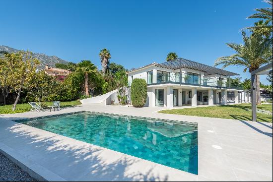 A spacious, contemporary villa with views of the sea and the mountains.