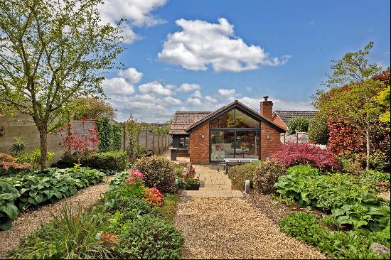 A stylish, contemporary two/three bedroom bungalow with outbuildings and delightful garden