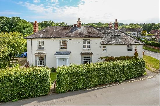 An impressive detached Grade II Listed period house situated in the heart of the village o