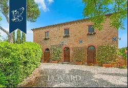 Prestigious renovated farmhouse with outbuilding for sale in the heart of the Crete Senesi