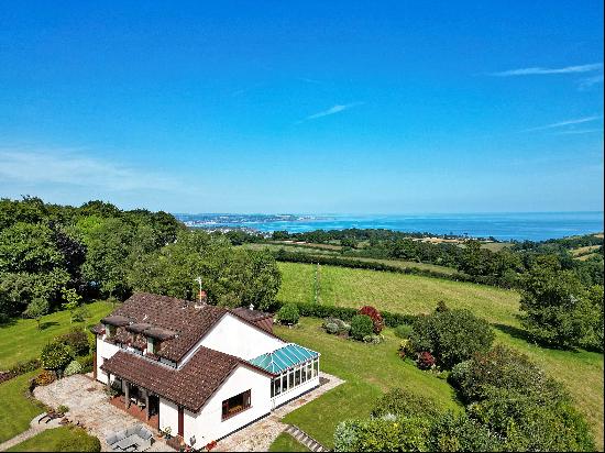 A fine detached home with four/five bedrooms and stunning sea views. A Large newly constru