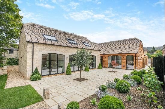 Set in the heart of an historic village on the edge of Cheltenham, a stunning detached new