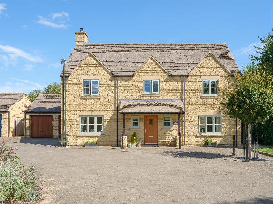 An attractive five bedroom Cotswold stone house, backing on to woodland and open fields be