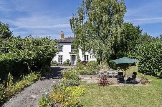 An attractive Georgian Grade II listed house, tucked away in a private setting up a long d