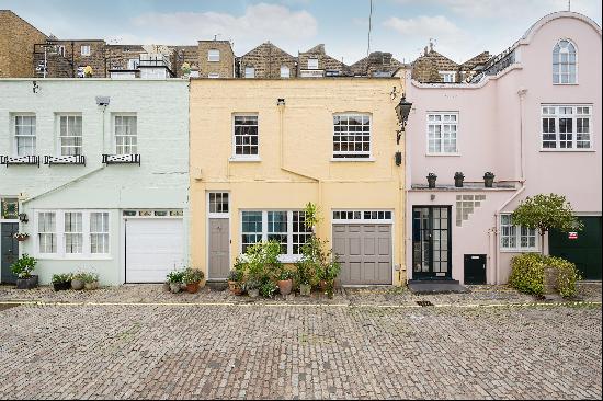 Located on a quiet cobbled mews, a three bedroom house for sale in Conduit Mews, Hyde Park