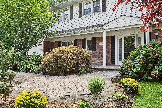 Welcome to this 6 BR, 5 BA, expanded balconied Colonial in the highly desirable village of