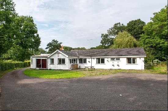 A spacious, detached bungalow with development potential set in a secluded location near t