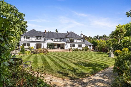 An impressive seven bedroom lateral house set in approx. 0.8 acres in the heart of Oxshott