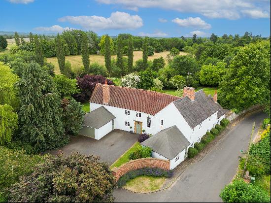 An imposing edge of village family house in about 1.57 acres with fine views.